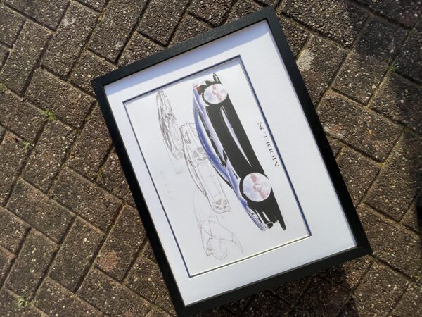 Framed Tesla Model S concept art print featuring original design sketches and a full-color rendering by Franz von Holzhausen.